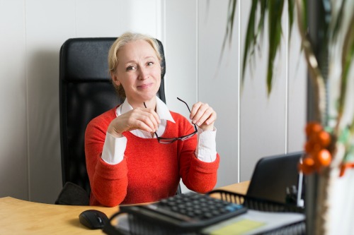 Attractive caucasian blonde business woman working in the office